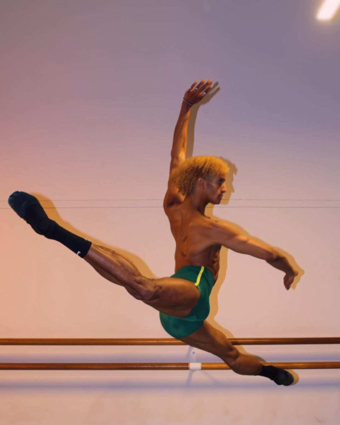Davi Ramos wearing GENTS Brazil Collection 1/4 shorts in ballet leap