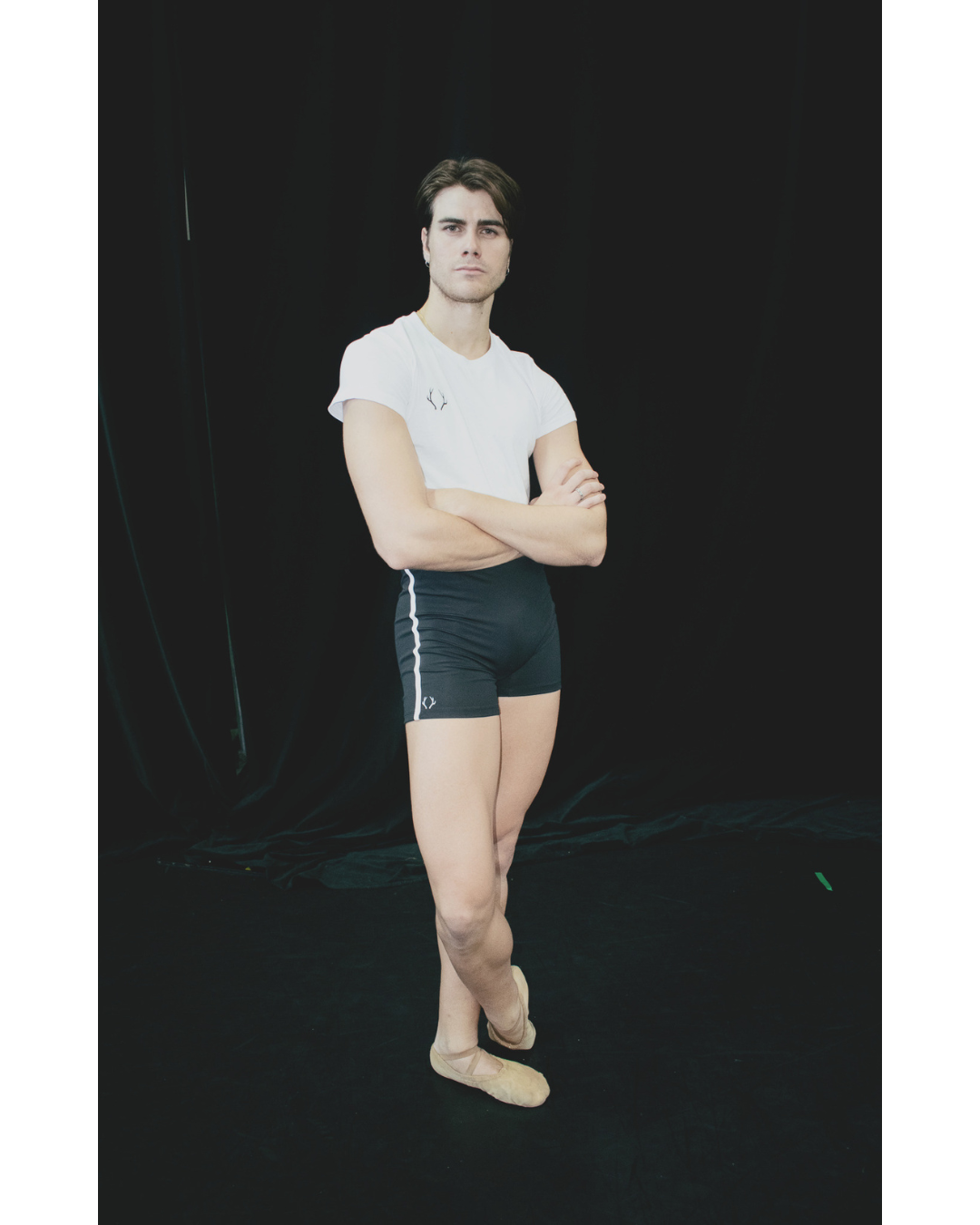Male dancer wearing white GENTS tee, front view 